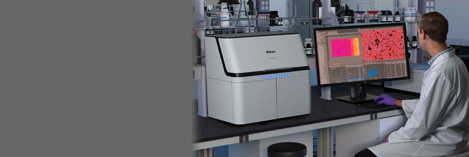 Scientist using a Nikon microscope in a laboratory